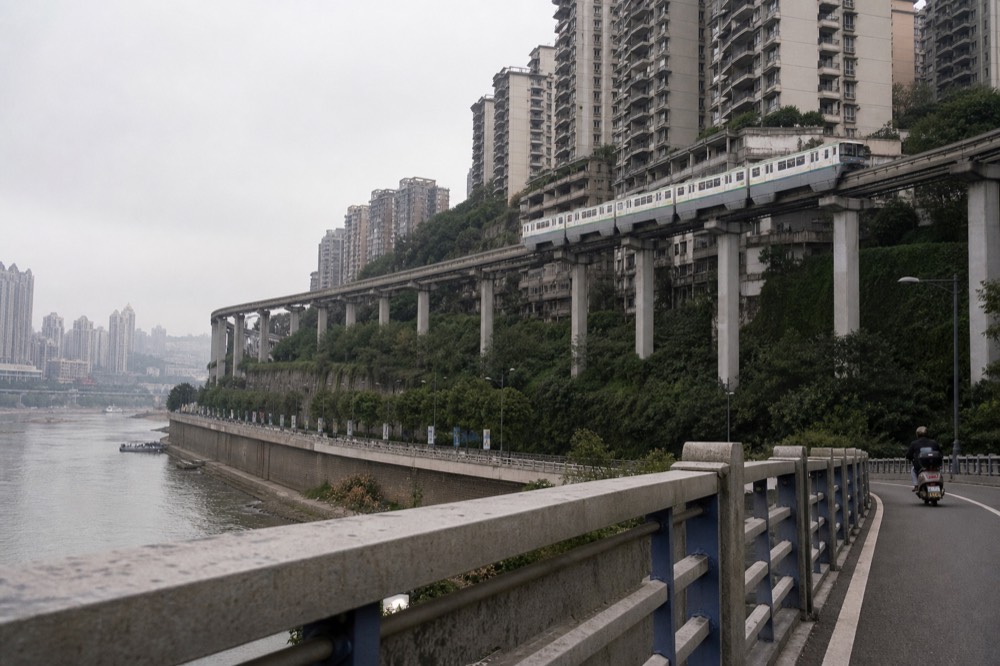 Elevated monorail track curving between high-rise buildings in daylight