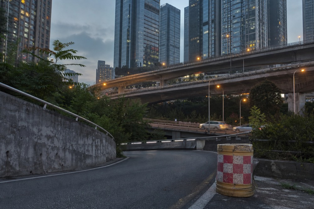 Elevated roadways crossing at different levels between high-rise apartment towers