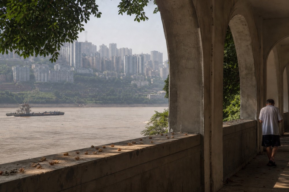 Heat haze over dense apartment blocks on hillsides in late afternoon light