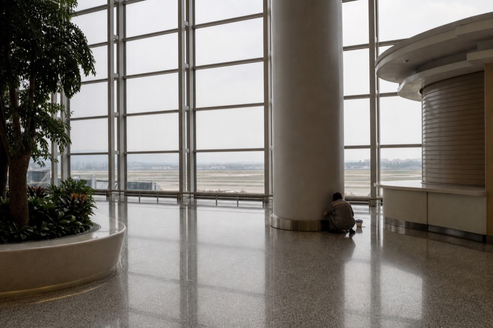 Modern airport terminal concourse with tall glass walls in China