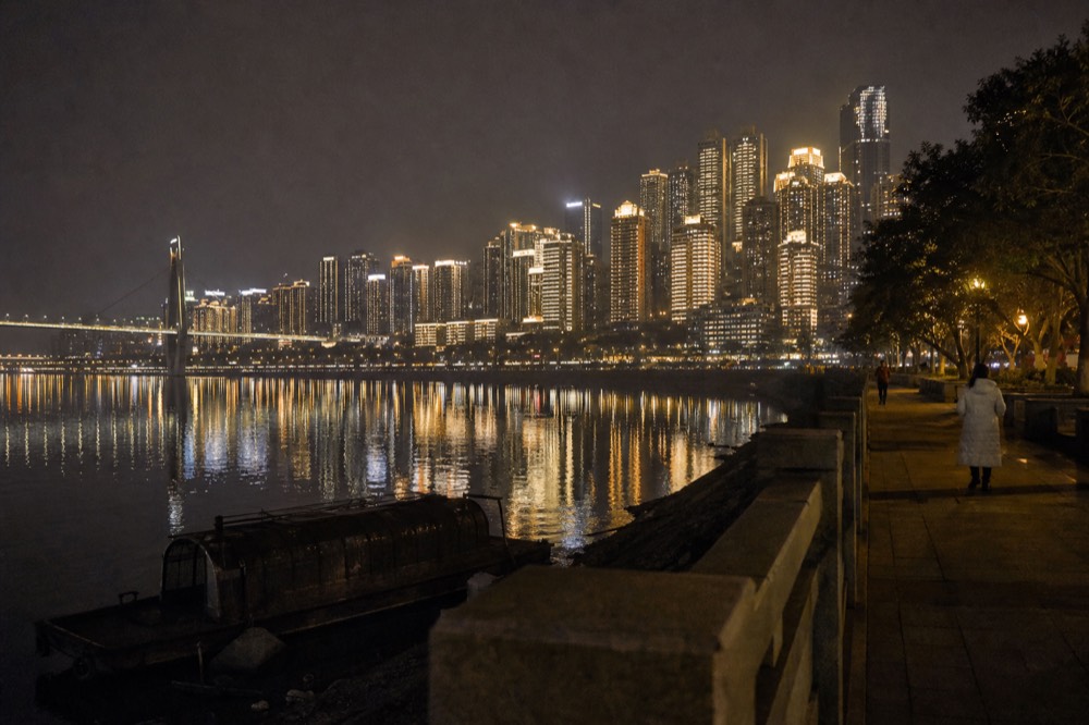 Illuminated high-rise skyline across the Yangtze River at night