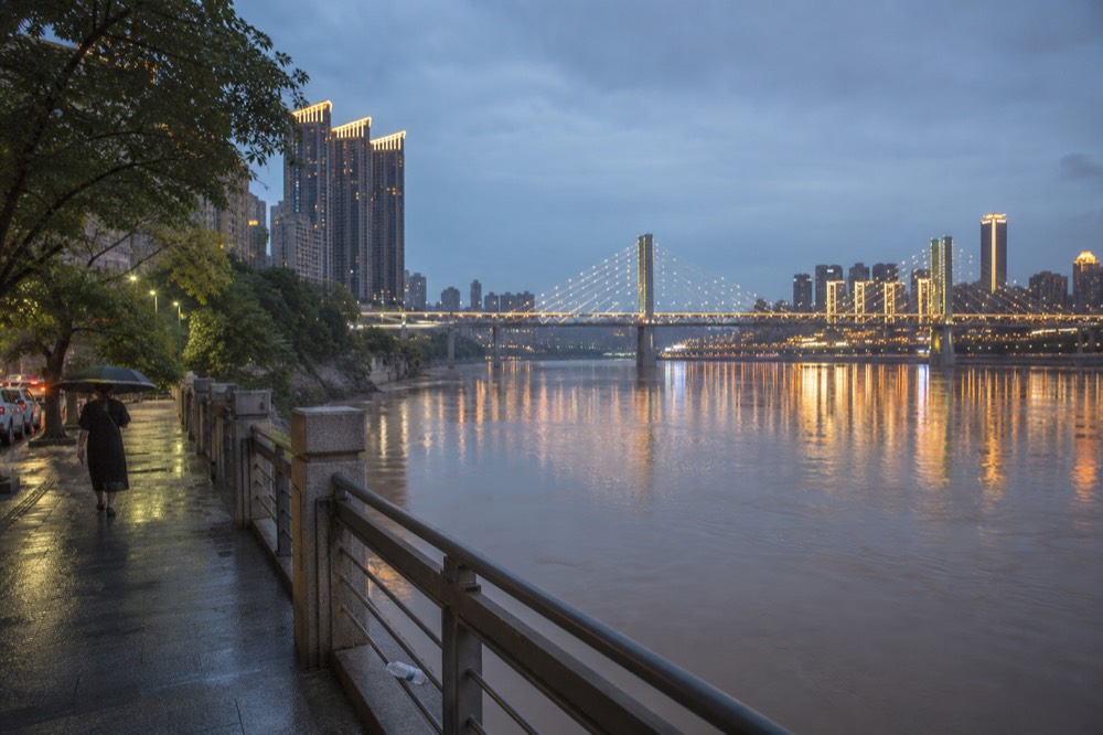 Chongqing riverside towers reflected in the Yangtze at blue hour