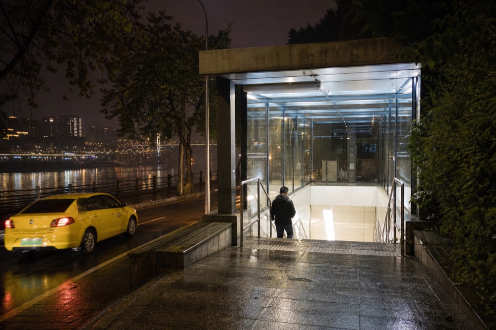 Metro station entrance on the south bank at night near the river